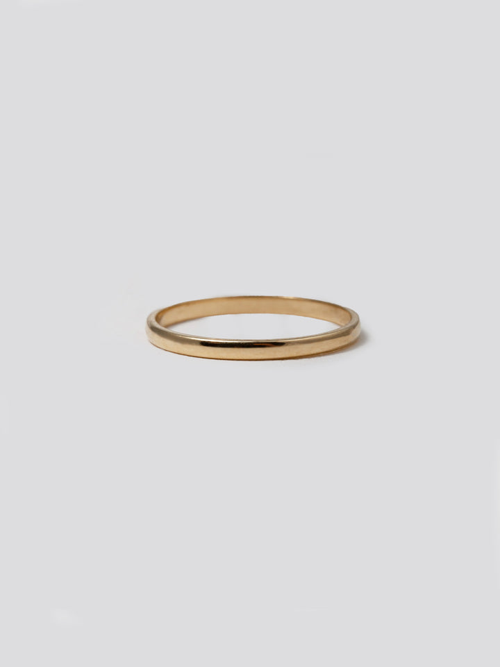 14Kt Yellow Gold Petite Eternity Band pictured on light grey background.