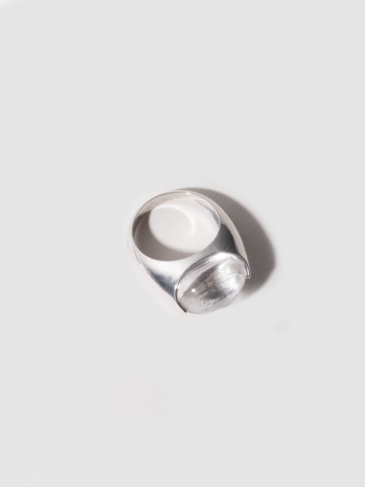 Silver ring on a light gray background