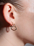 14kt Yellow Gold XL Angled Heart Hoops pictured on models ear paired with the Standard Heart Feels hoops.