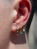 14kt Gold Rhodolite Huggies pictured in first piercing along with White Sapphire and Tsavorite.