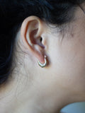 14kt Yellow Gold Many Moons Hoops pictured in models ear.