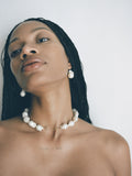 14kt Yellow Gold Safety Pin Baroque Pearl Collar pictured on model. Light grey background.