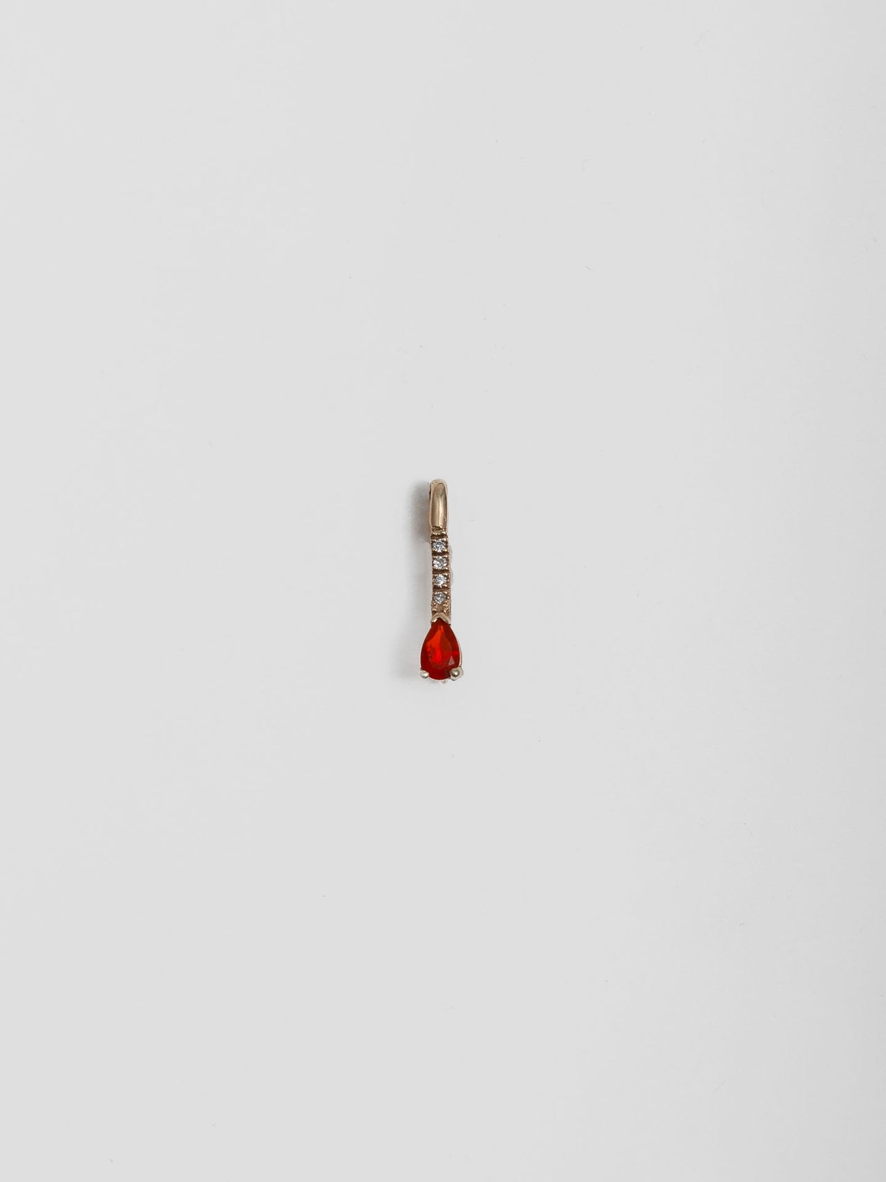 14kt Yellow Gold Mini Diamond Fire Opal Safety Pin pictured on light grey background. 
