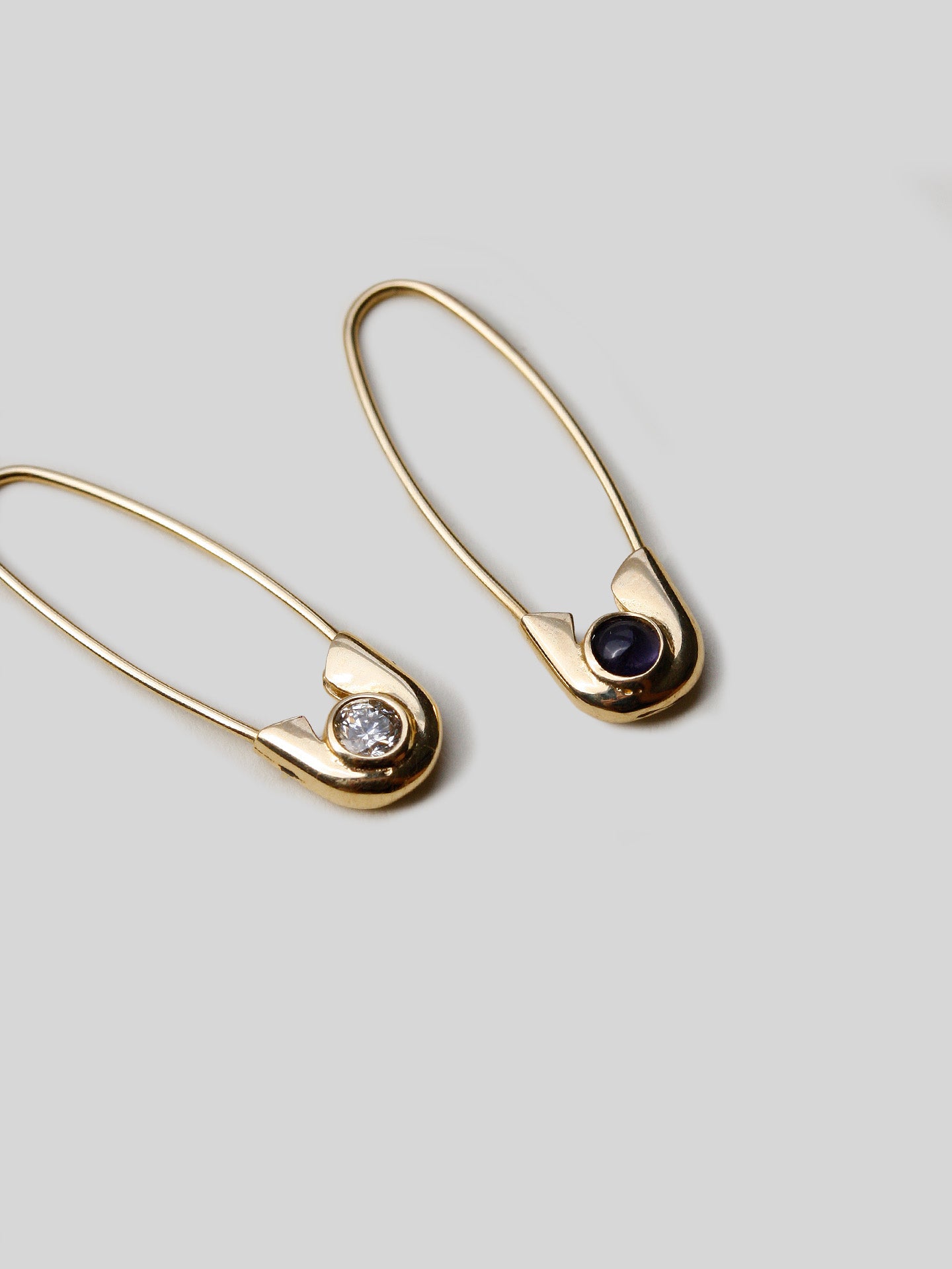 Flat of 14kt Yellow Gold Mini Diamond &amp; Sapphire Safety Pin pictured with the Blue Sapphire. 
