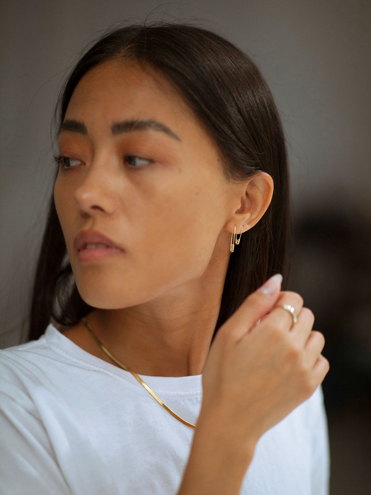 Mini & Standard 14Kt Yellow Gold Safety Pin Earrings pictured on model. 