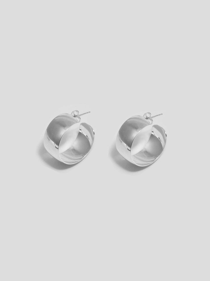 Sterling Silver Midi XL Dome Hoops pictured on light grey background. 