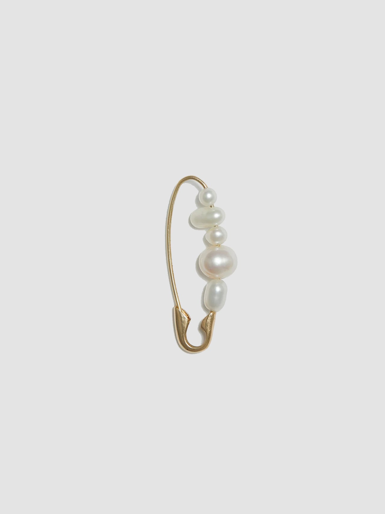 Product shot of the Mixed Pearl Safety Pin (14kt Yellow Gold Safety Pin 27mm Total Length Mixed Freshwater Pearls) Background: Grey backdrop
