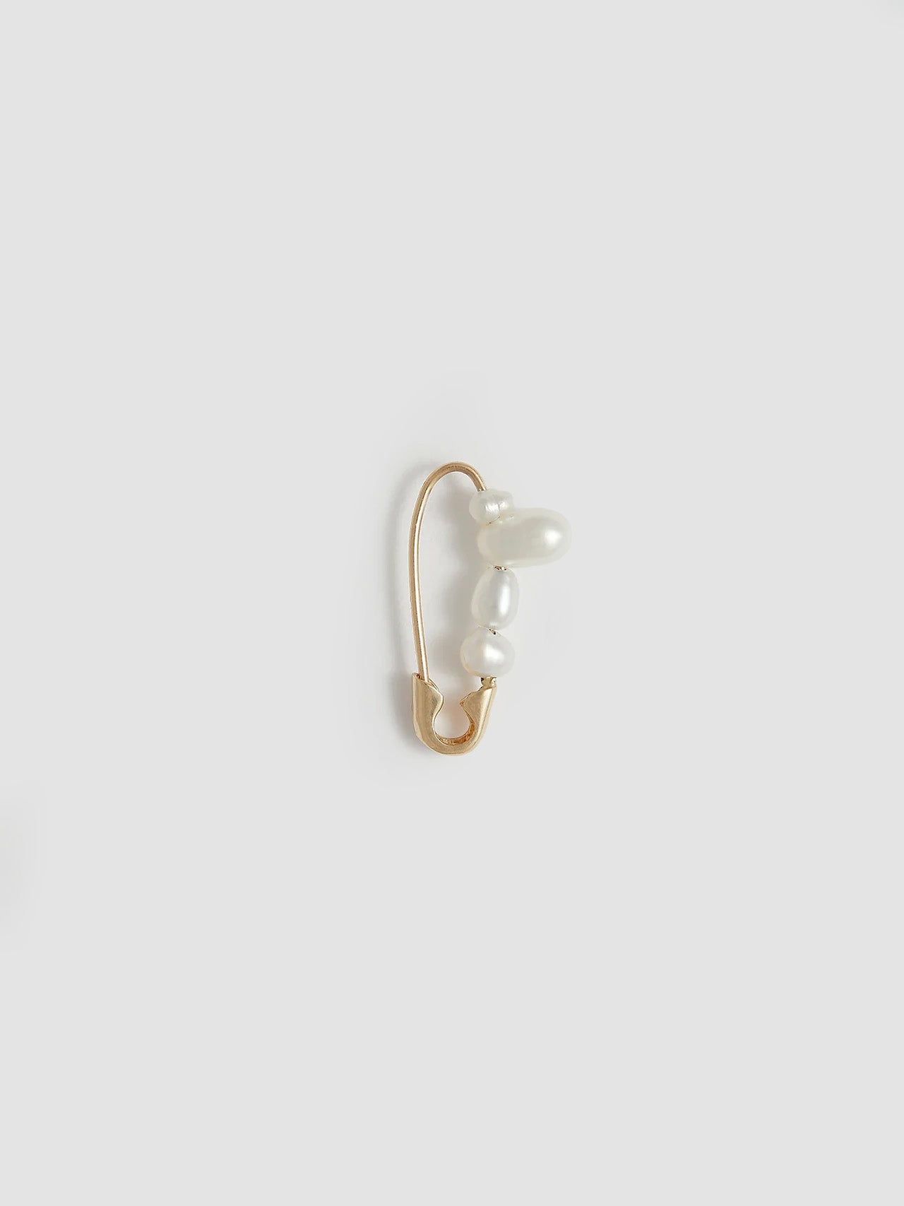 Product shot of the Mini Mixed Pearl Safety Pin Earring (14kt Yellow Gold Mixed Pearl Safety Pin Length: 17mm Mixed Freshwater Pearls) Background: Grey Backdrop