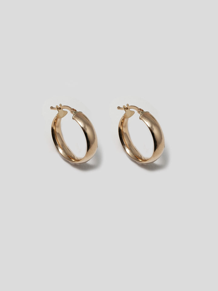 14kt Yellow Gold Hoops pictured on light grey background.