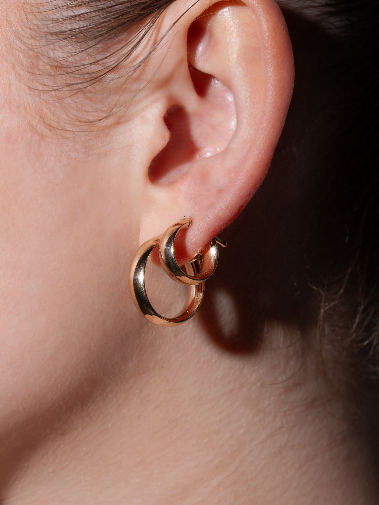 14kt Yellow Gold Midi Legacy Hoops pictured on model along with Mini Legacy Hoops.