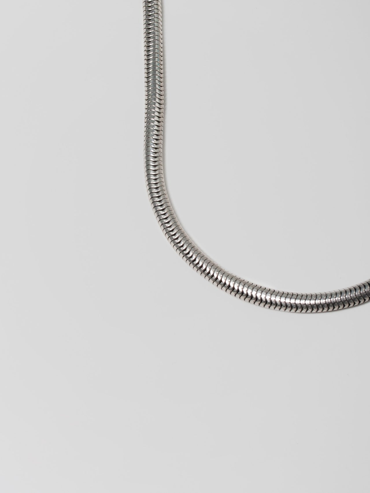 Sterling Silver XXL Snake Chain Necklace shot on light grey background.