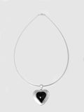 Sterling Silver Onyx Heart Medallion Necklace shot on white background.