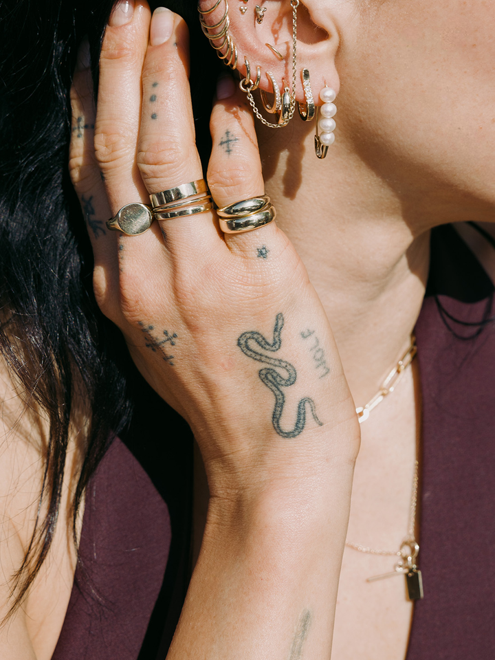 14kt Yellow Gold Dome Band pictured on models pinky finger. Stacked with the signature Dome Ring.