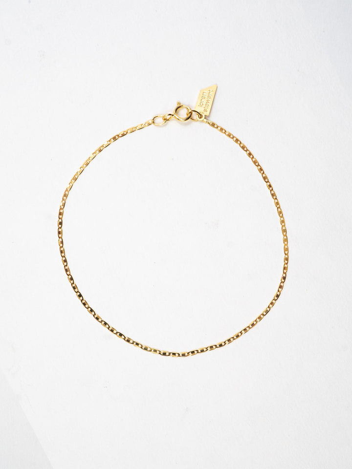 10kt Yellow Gold Valentino Chain Bracelet pictured on light grey background.