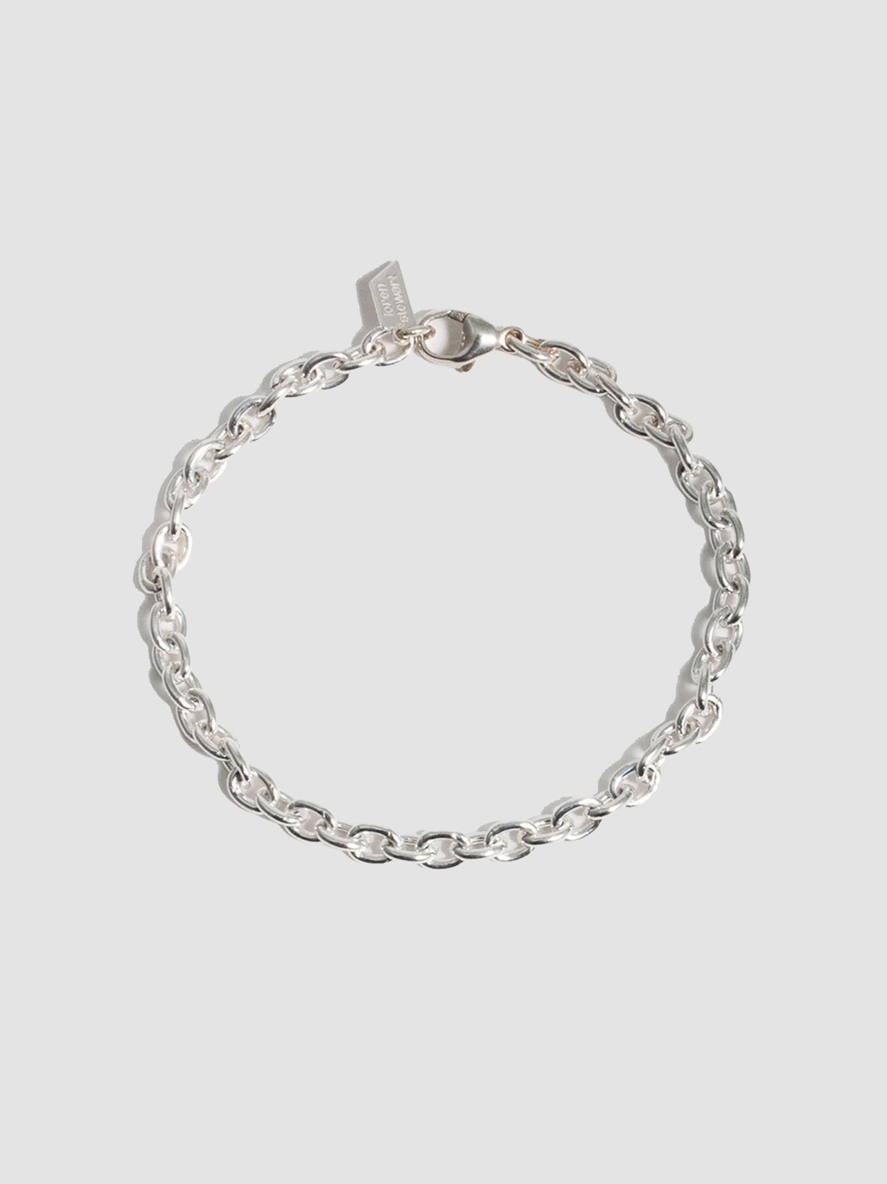 Sterling Silver Cable Chain Bracelet pictured on light grey background. 