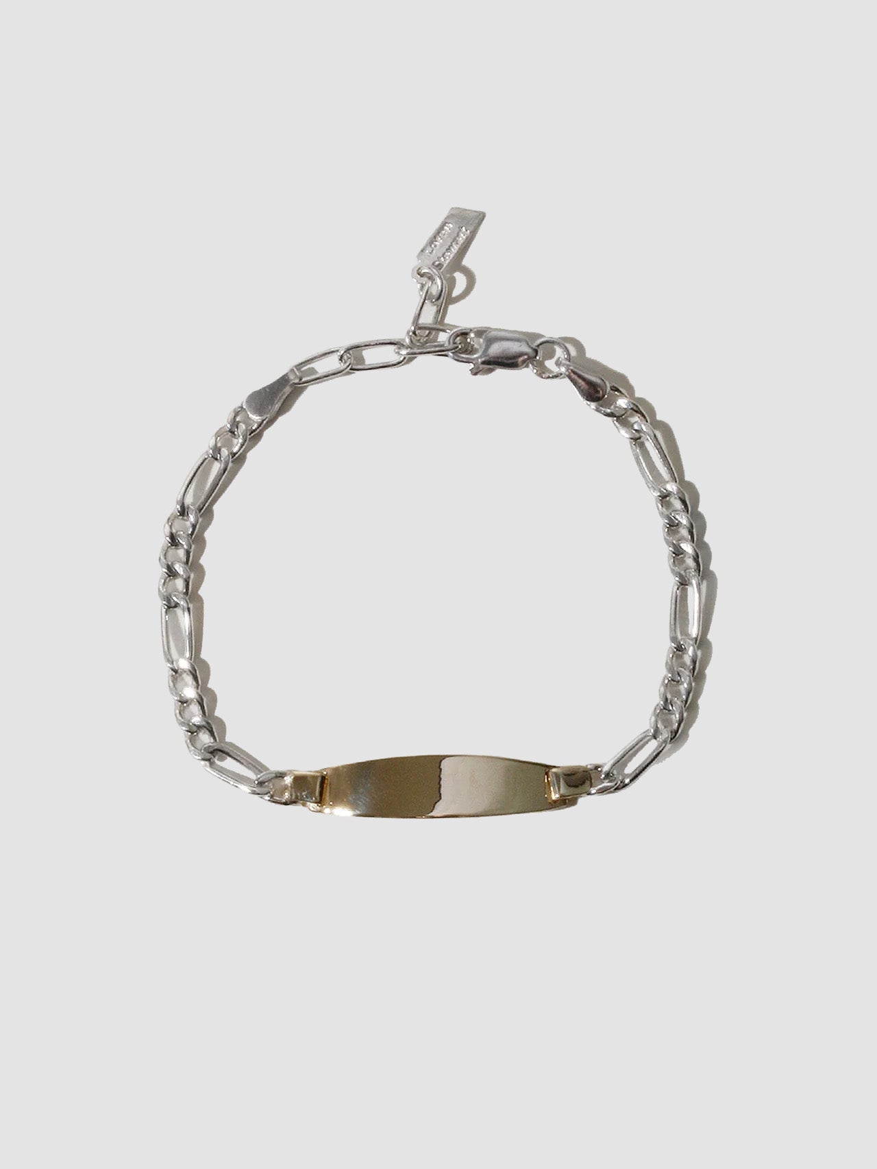 Silver bracelet with a nameplate on a light gray background