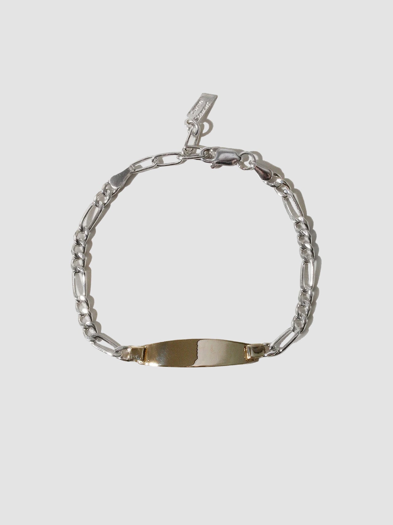 Silver bracelet with a nameplate on a light gray background