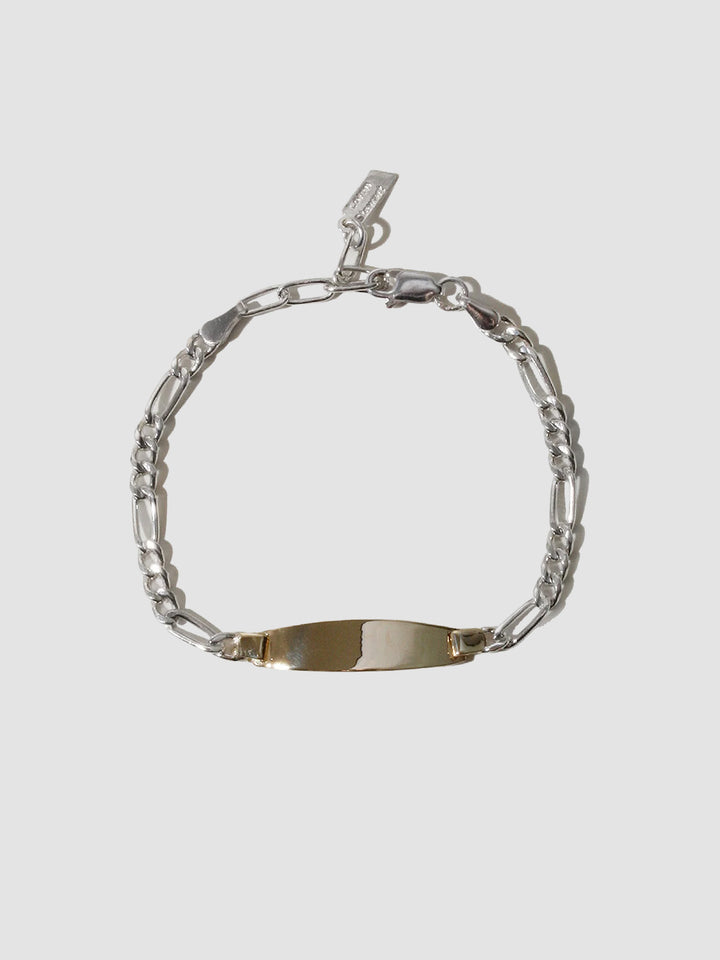 Silver bracelet with a nameplate on a light gray background