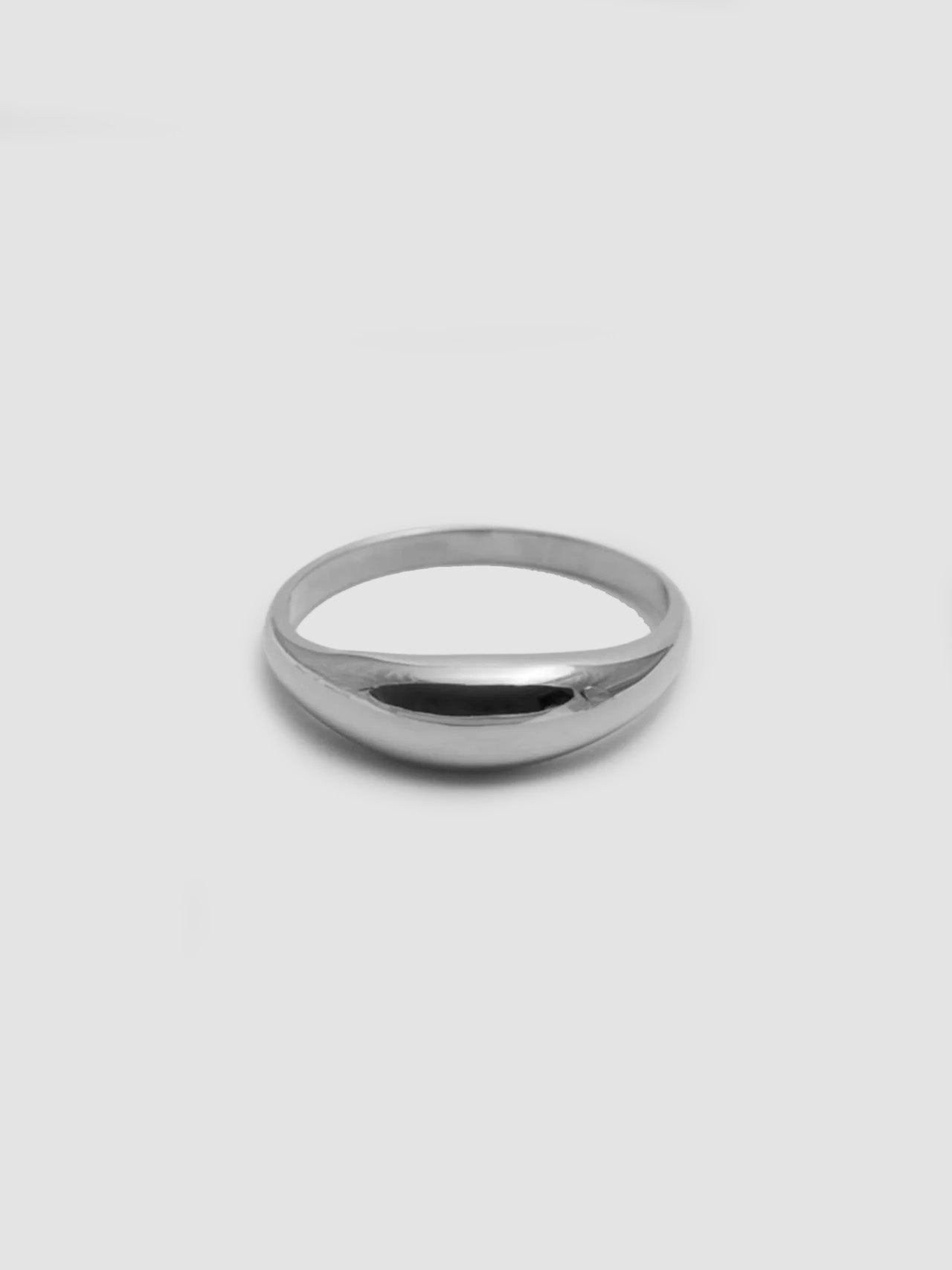 A silver dome-shaped stacking ring on a plain background.