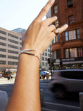 Vermeil Classico Opal Signet Ring pictured on models pinky finger. City background.