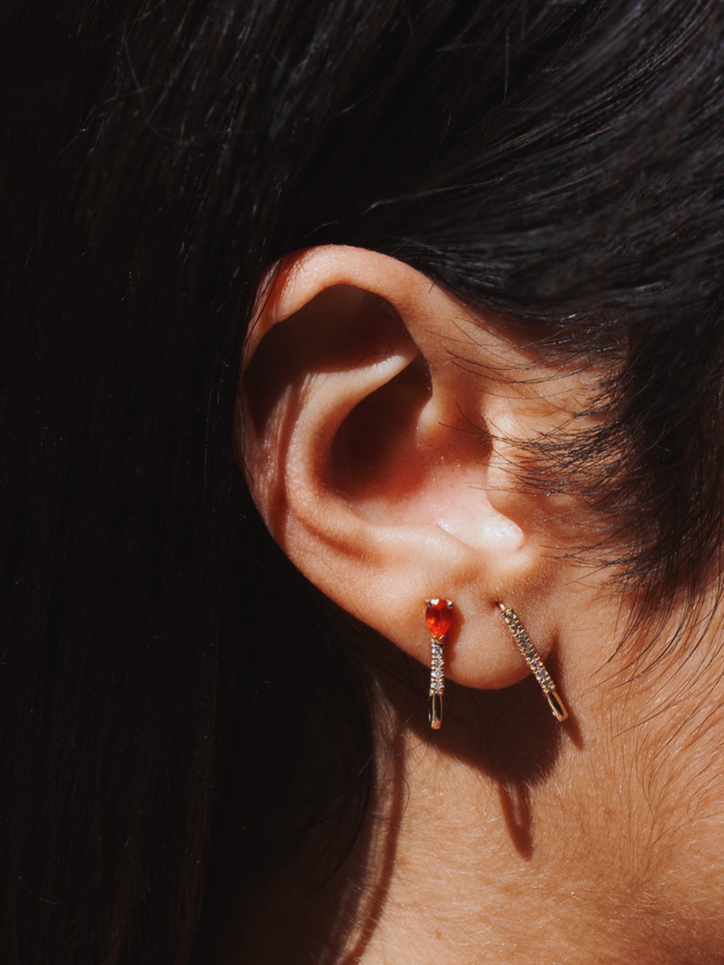 14kt Yellow Gold Mini Diamond Fire Opal Safety Pin pictured in models second piercing.