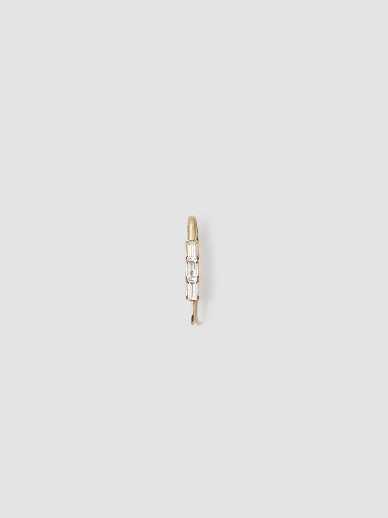 14kt Yellow Gold Mini Baguette Safety Pin Earring pictured on light grey background. 