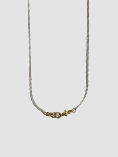 Necklace with a gold clasp on a light gray background