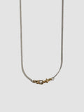 Necklace with a gold clasp on a light gray background