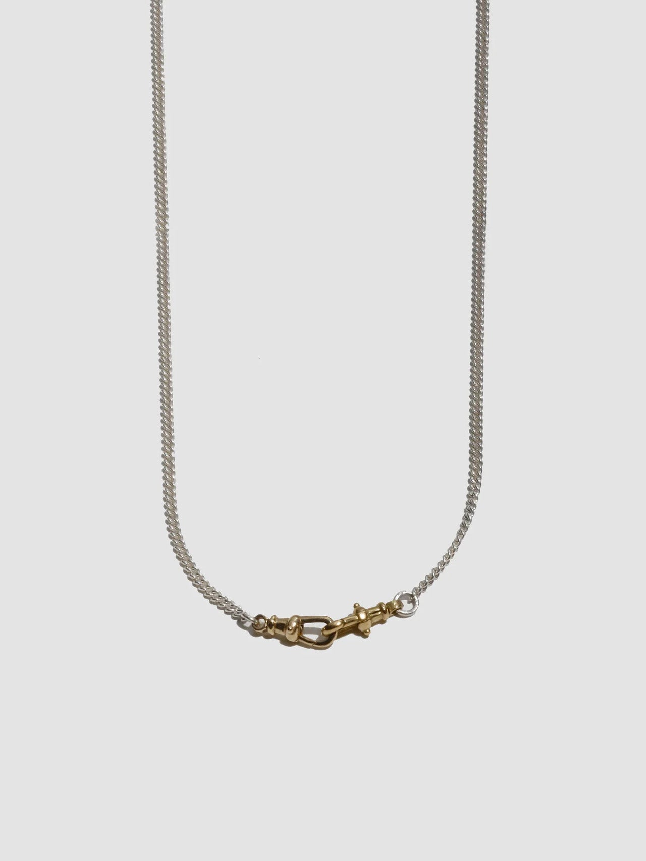 Necklace with a gold clasp on a light gray background