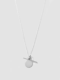 Silver necklace with a round pendant on a light gray background