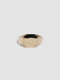 Gold ring on a light gray background