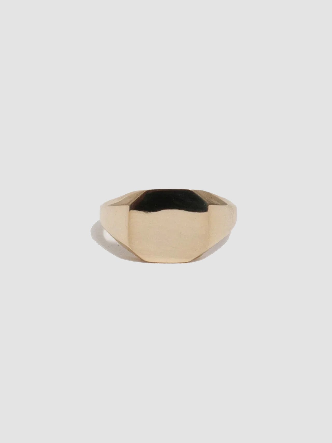 Gold ring on a light gray background