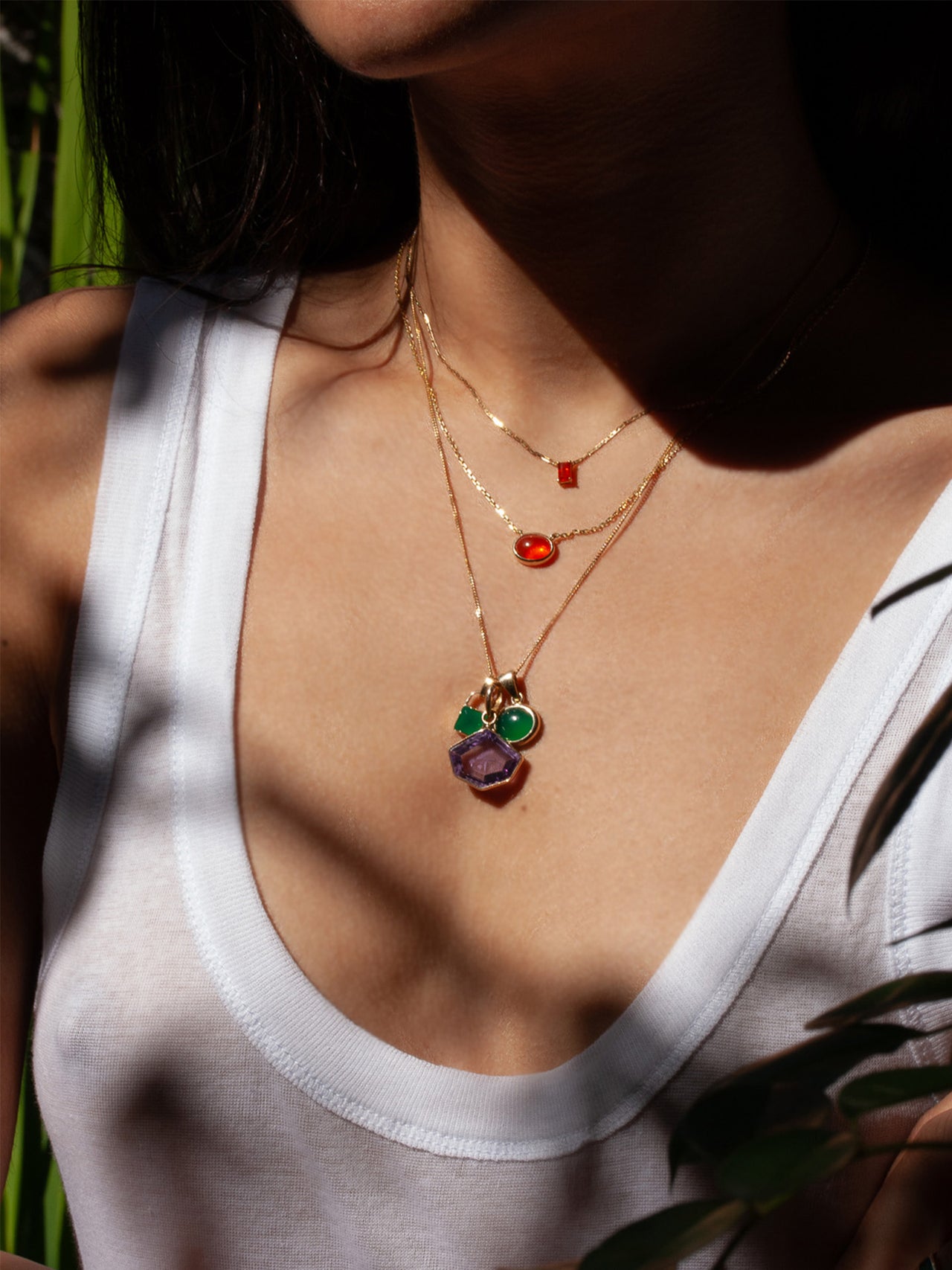 Fire Opal Cabochon Necklace pictured on model. Layered with other gemstone necklaces.