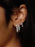 14kt Yellow Gold XL Pearl Safety Pin Earring pictured in models first piercing. 