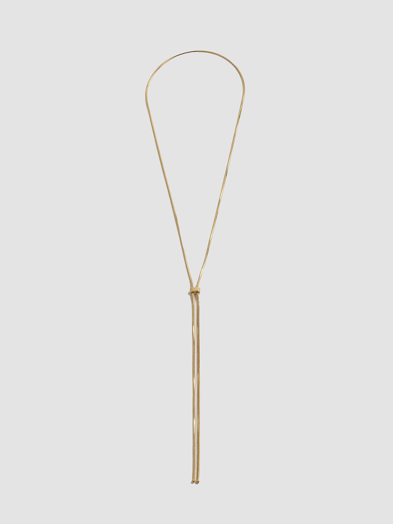 Vermeil Bolo Pendant Necklace shot on light grey background.