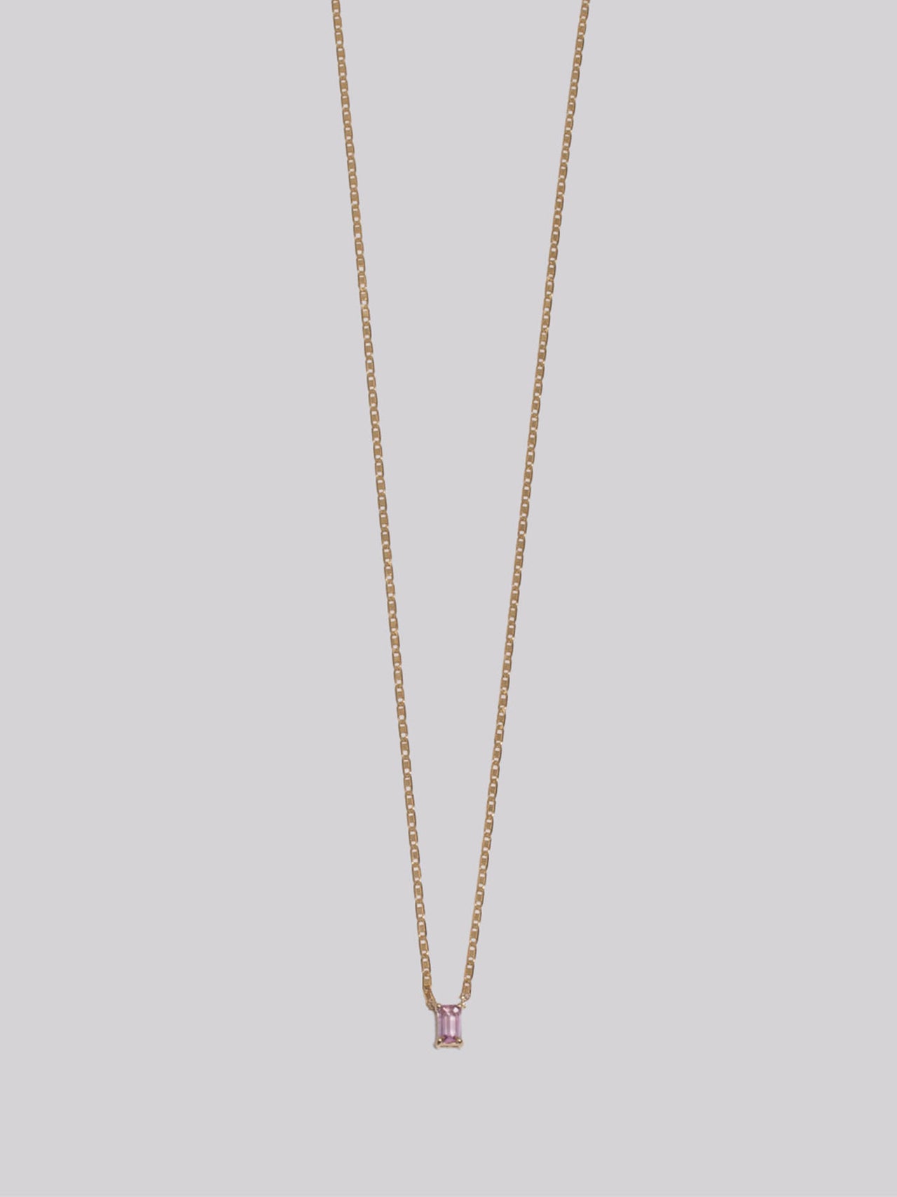 10k Yellow Gold Sapphire Valentino Necklace pictured on light grey background. 