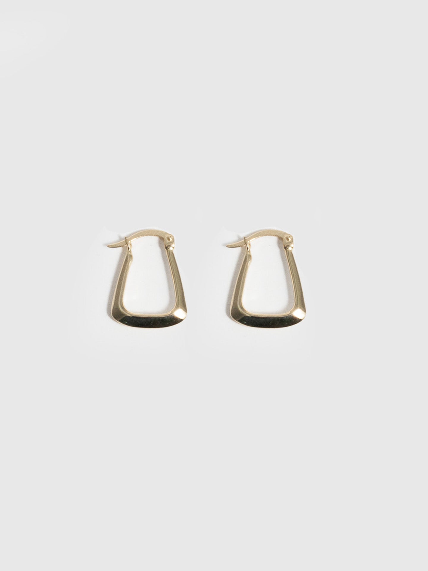 14kt Yellow Gold Hoops Trifecta Hoops pictured on light grey background. 