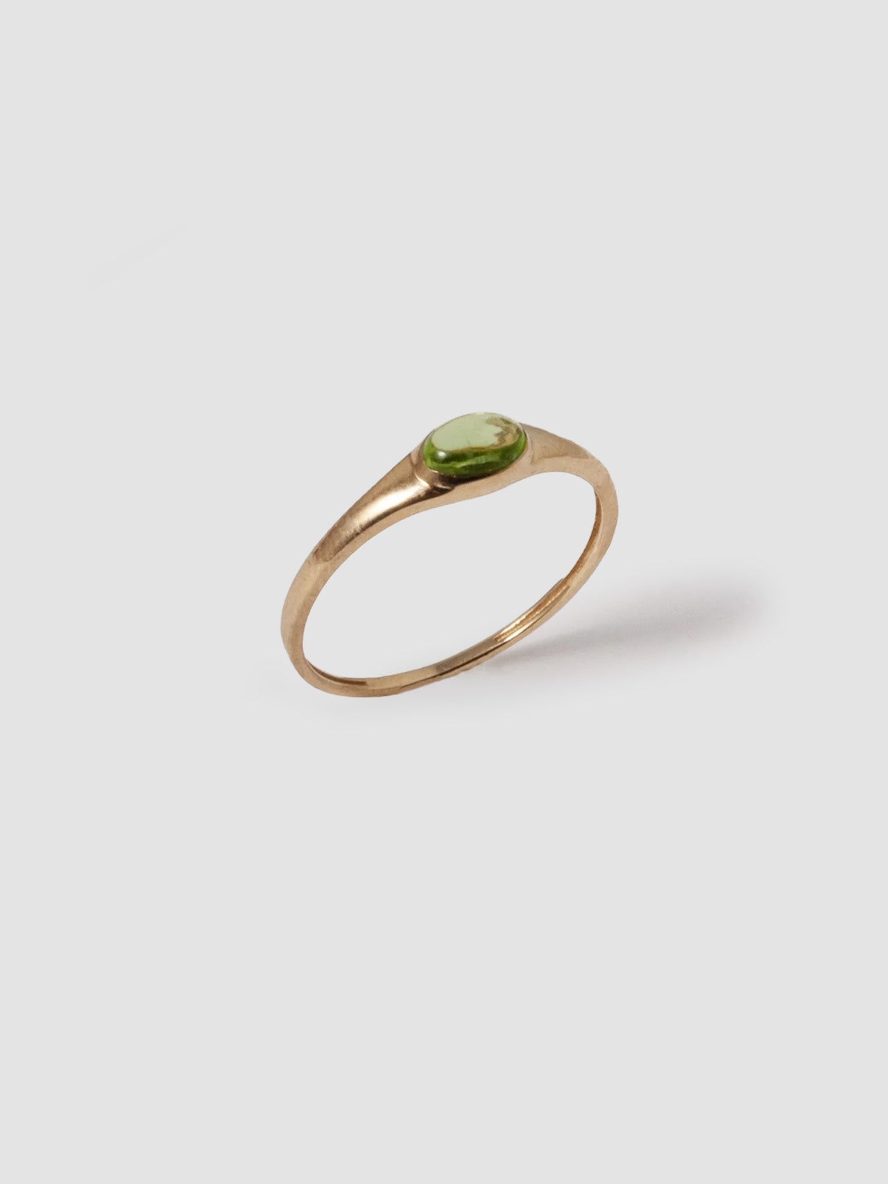 14kt Yellow Gold Signet Mini Gem Signet pictured on light grey background. Peridot stone. 