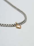 Close  up of Gordita Necklace: Sterling Silver Round Box Chain with 14kt Yellow Gold Puff Heart Pendant