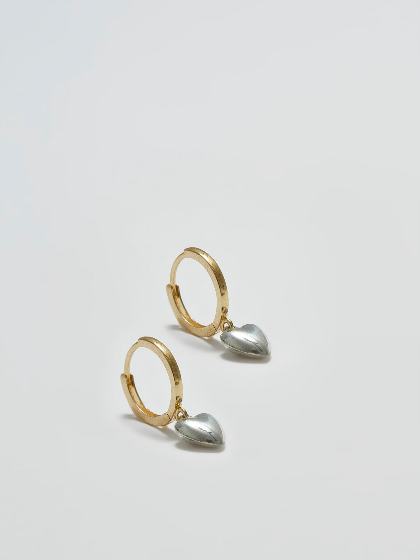 Product angle shot of Gordita Heart Huggies (10kt Gold Click On Huggies 11.5mm Diameter Sterling Silver Puff Heart 6mm) shot on white background