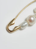 Product shot of the Mixed Pearl Safety Pin (14kt Yellow Gold Safety Pin 27mm Total Length Mixed Freshwater Pearls) Background: Grey backdrop
