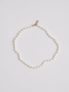 White Freshwater Rice Pearl Anklet pictured on light grey background. 