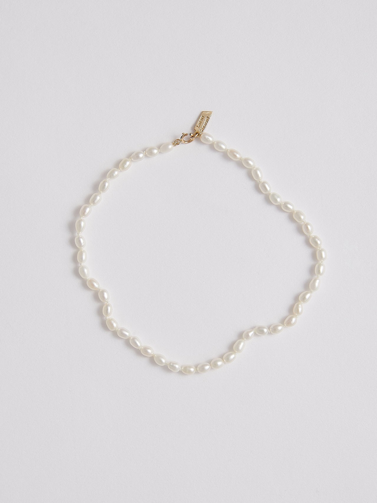 White Freshwater Rice Pearl Anklet pictured on light grey background. 