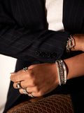 Zenith Bracelet shot on model. Layered with other sterling silver chains.