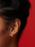 14kt Yellow Gold Pierced CZ Huggies pictured on models ear.