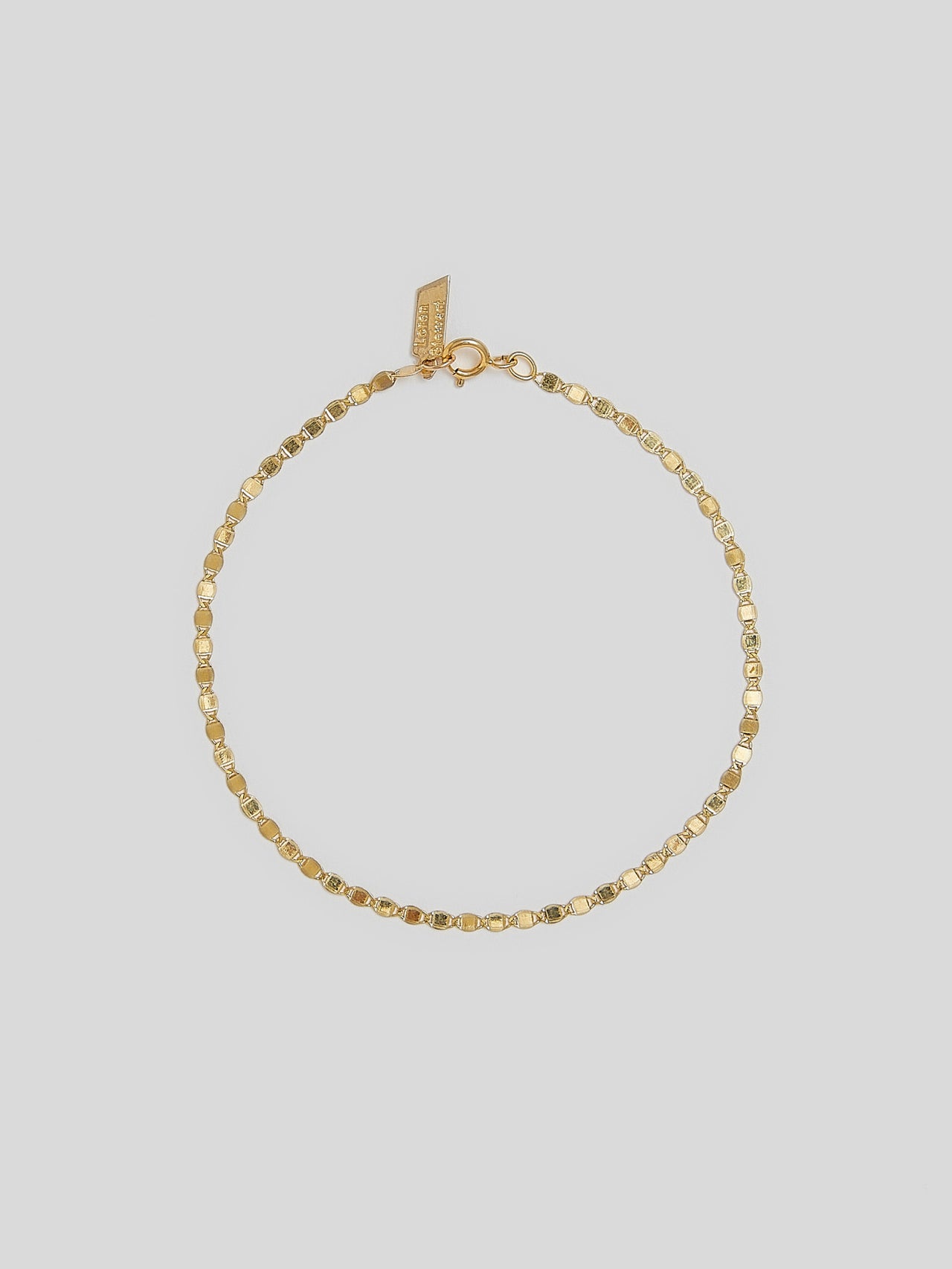 Product image of 14kt yellow gold valentino chain anklet on white background. 