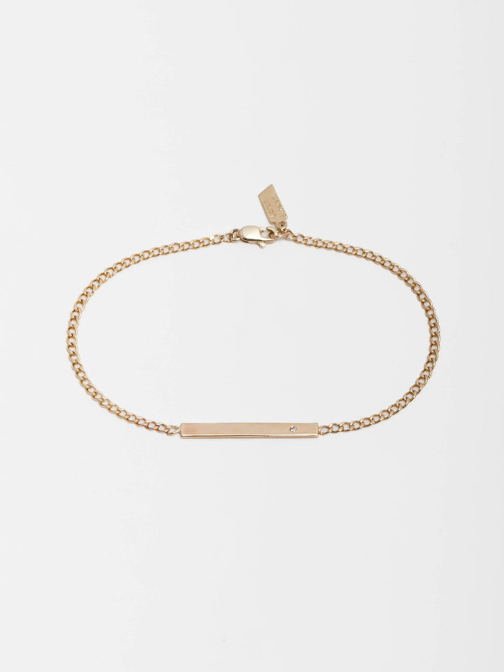 14kt Yellow Gold One Diamond ID Bracelet pictured on light grey background. 