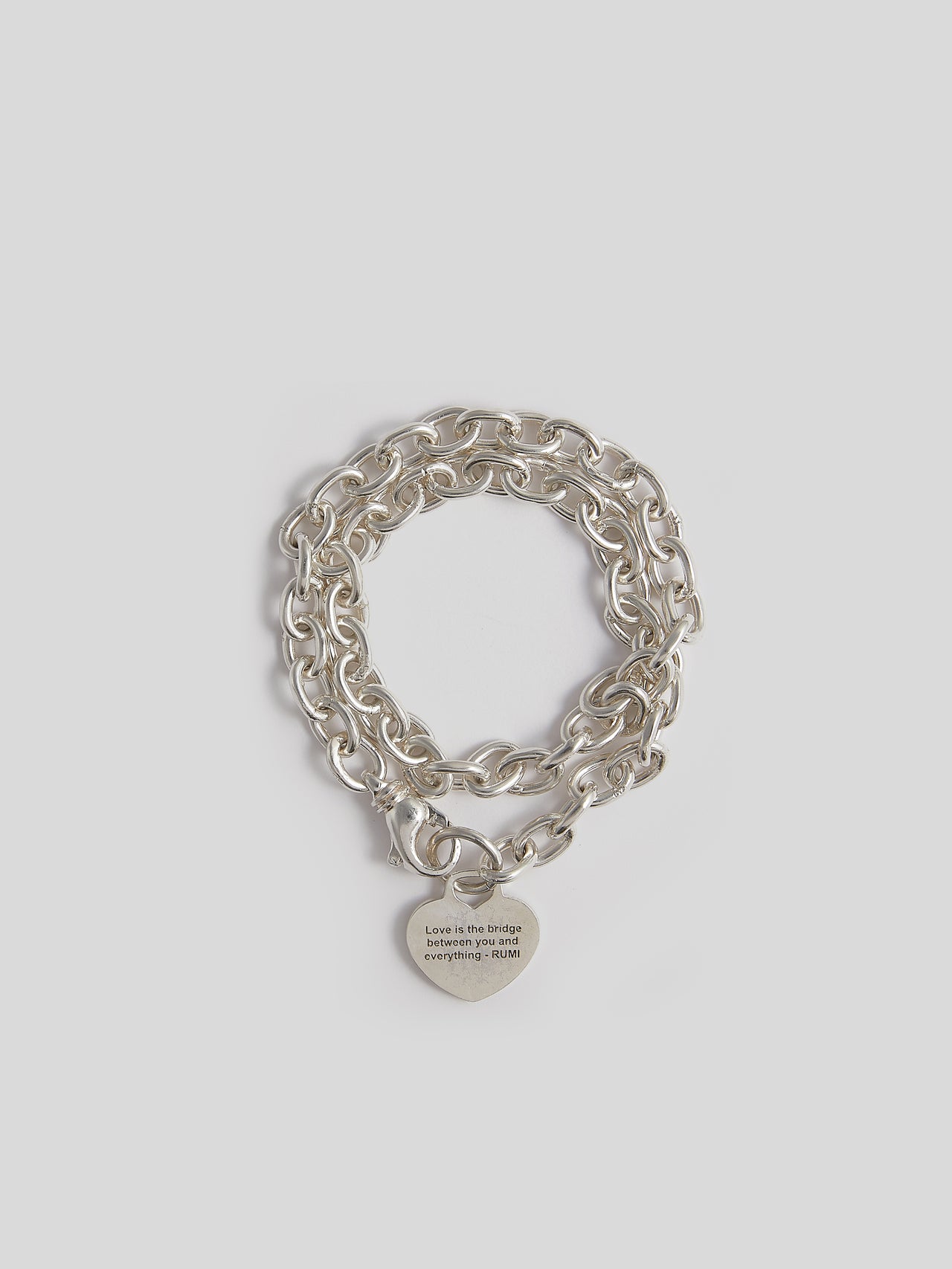 Sterling Silver Rumi Wrap Charm Bracelet pictured on light grey background. 