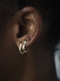 Close up of Serpent Huggie Earring Set shot on model 