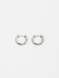 14Kt White Gold & Diamond Huggie Earrings pictured side by side on light grey background. 